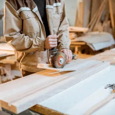 Circular saw cutting timber with sawdust in the air