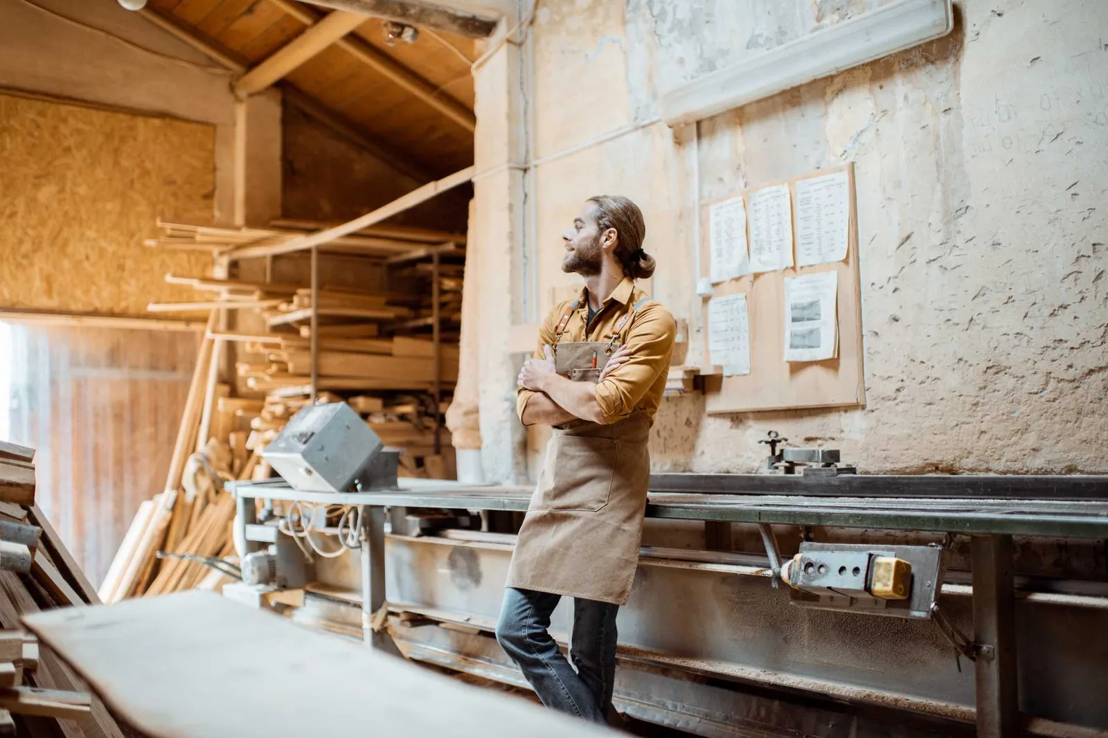 Aaron in the workshop in front of the timber racks