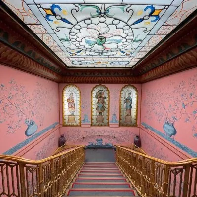 Hallway of a period home lit through a restored stained glass window